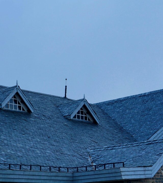 Residential roofing experts working on a home in Westchester County, NY.